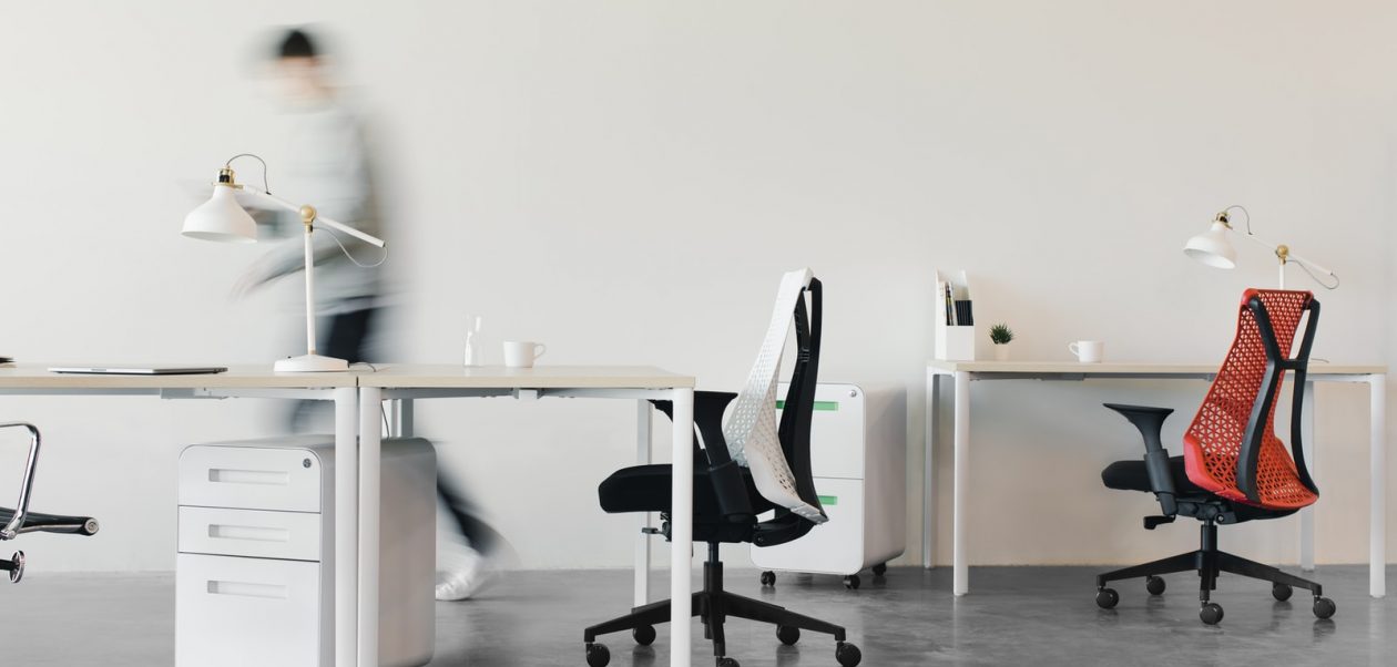woman in white long sleeve shirt sitting on black office rolling chair