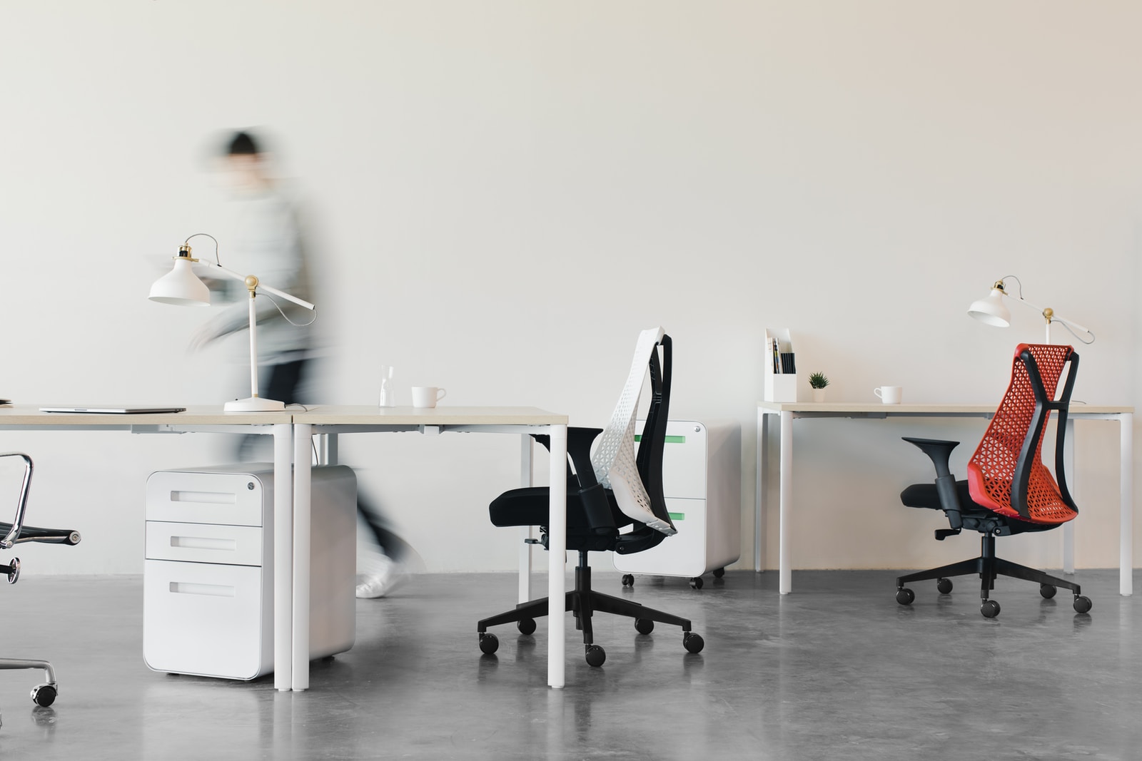 woman in white long sleeve shirt sitting on black office rolling chair